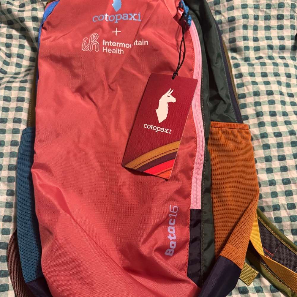 cotopaxi coral and orange Batac daypack with pink zipper